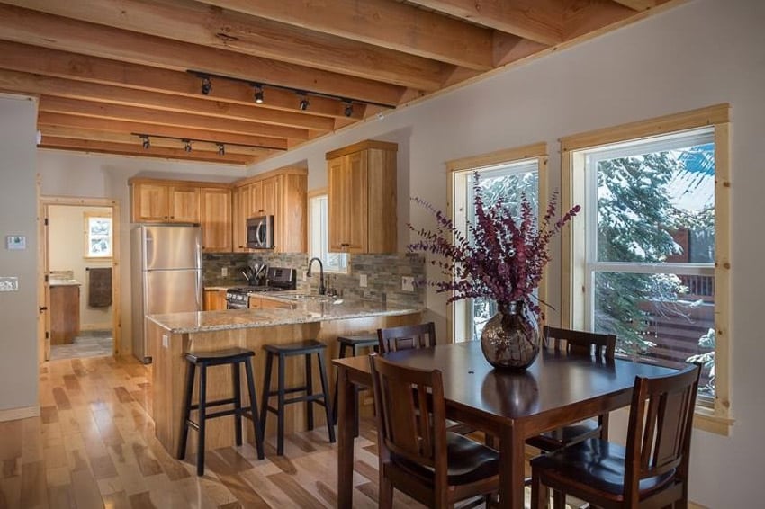 Small rustic wood kitchen with amber yellow granite counters