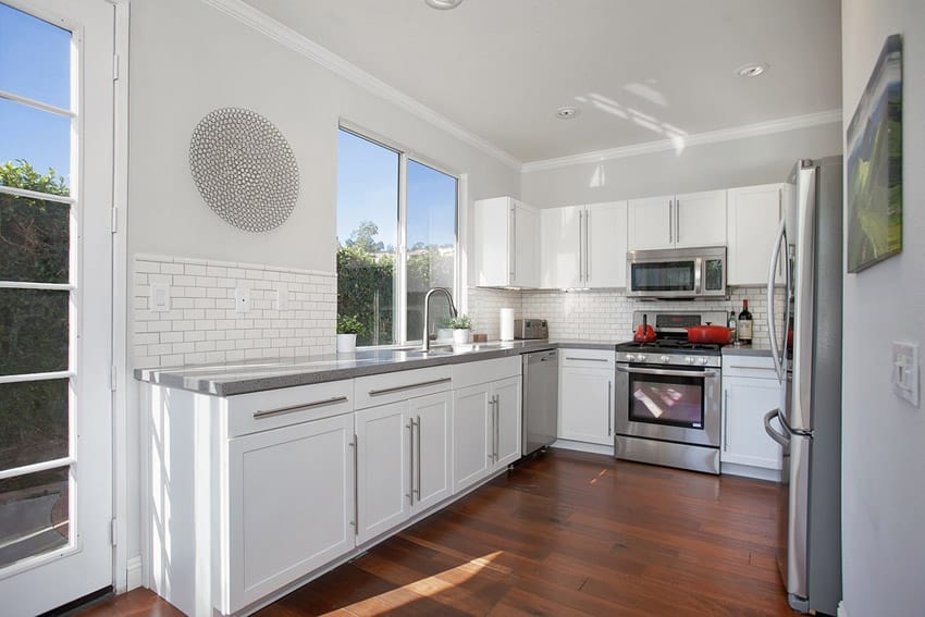 Small white kitchen with hardwood floors