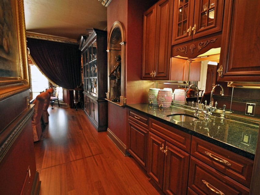 Traditional small galley kitchen with Cambrian black granite counters