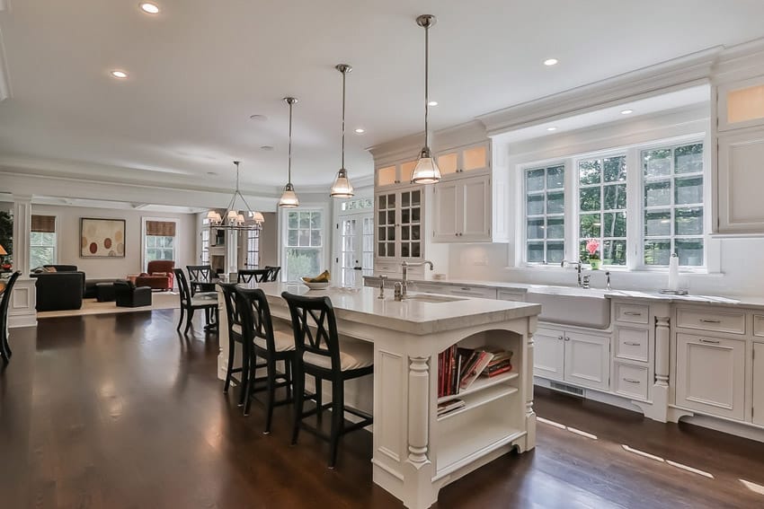 Traditional white kitchen dining island open to living room