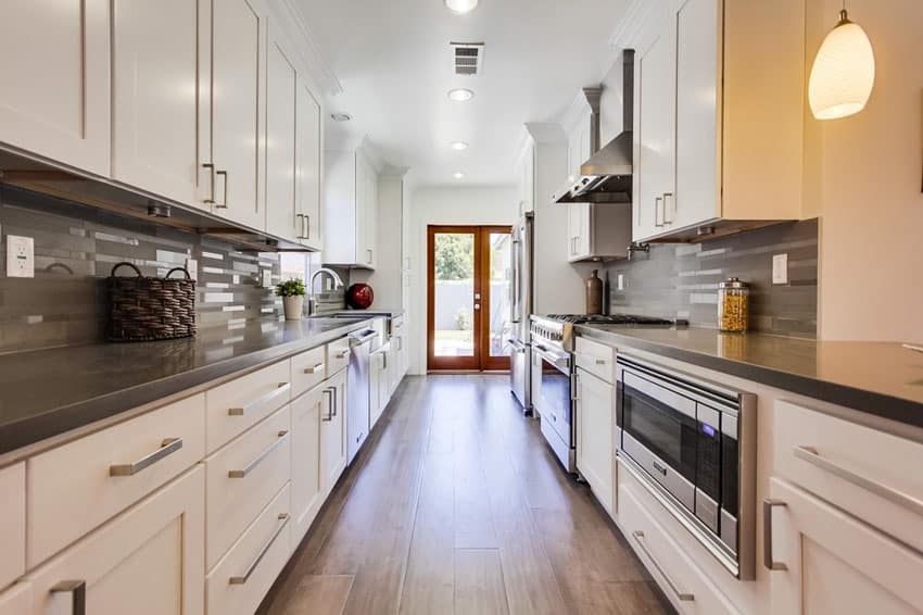 Contemporary white galley kitchen with gray quartz countertops