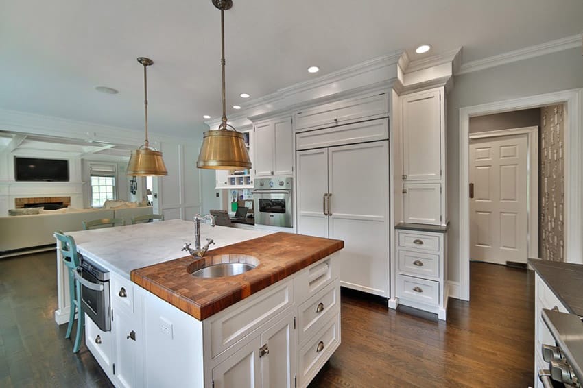 Kitchen with painted white cabinets and marble and wood combination countertops