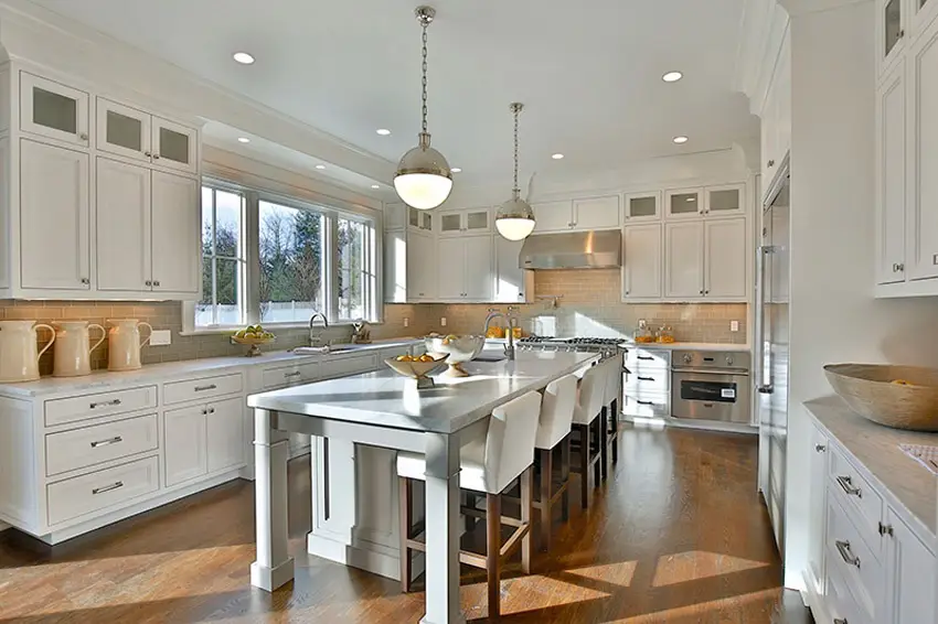 Kitchen with main cabinets painted white and marble counter top