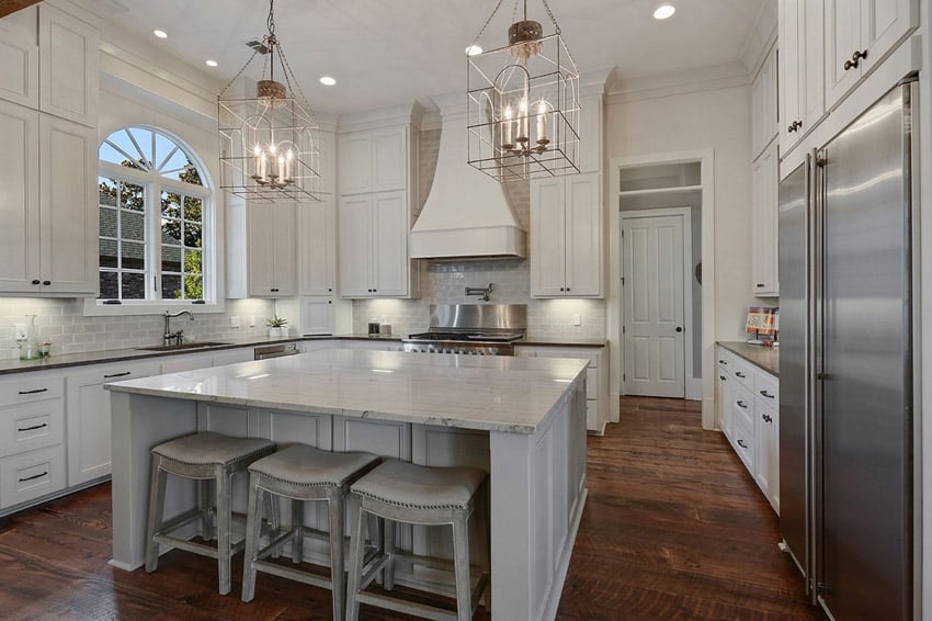 White kitchen with marble counters large dining island