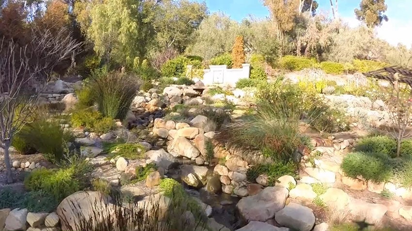Backyard water feature stone river at luxury home