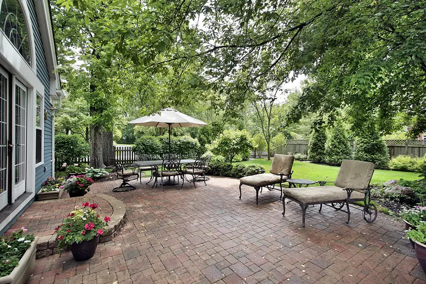 Beautiful brick patio green trees umbrella