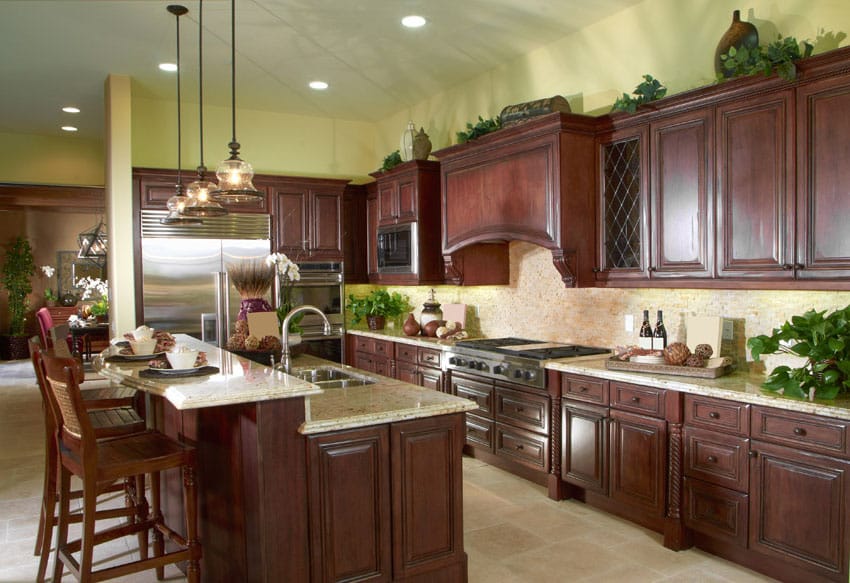 Kitchen with wooden barstools and yellow mosaic tile backsplash