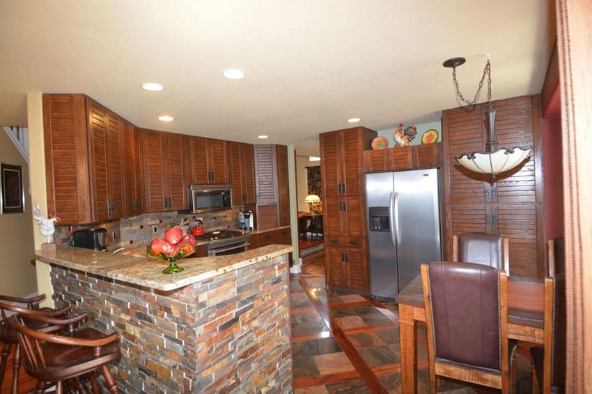 Country kitchen with brick peninsula and granite counters