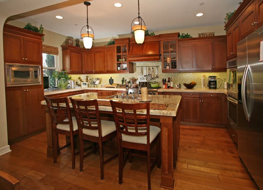 Kitchen with dark wooden cabinets, kitchen island with slatback chairs