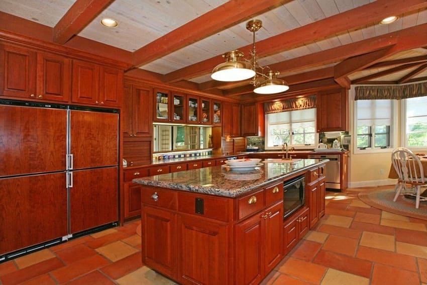 Craftsman kitchen with cherry cabinetry and exposed beam ceiling