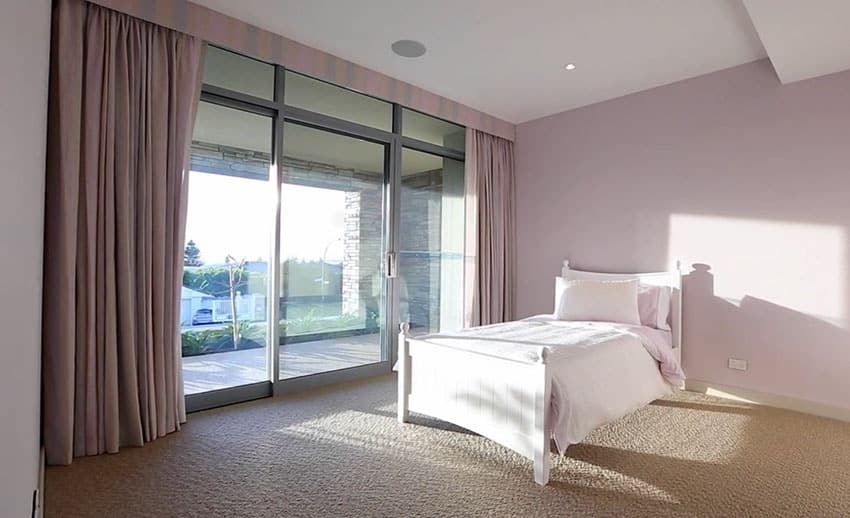 Girls bedroom in modern home with lavender walls and curtains