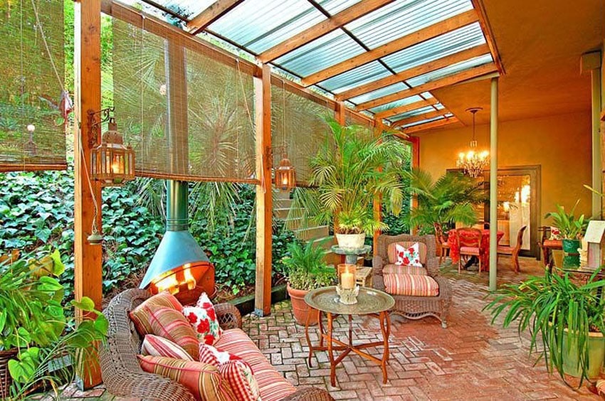 Enclosed brick patio with rolling screens for sunshade