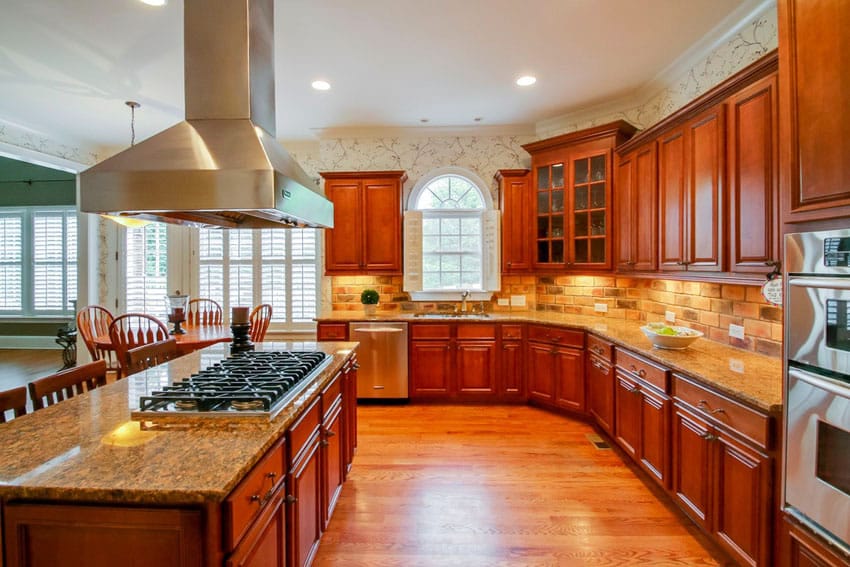 Kitchen with brick backsplash and bright wood cabinetry