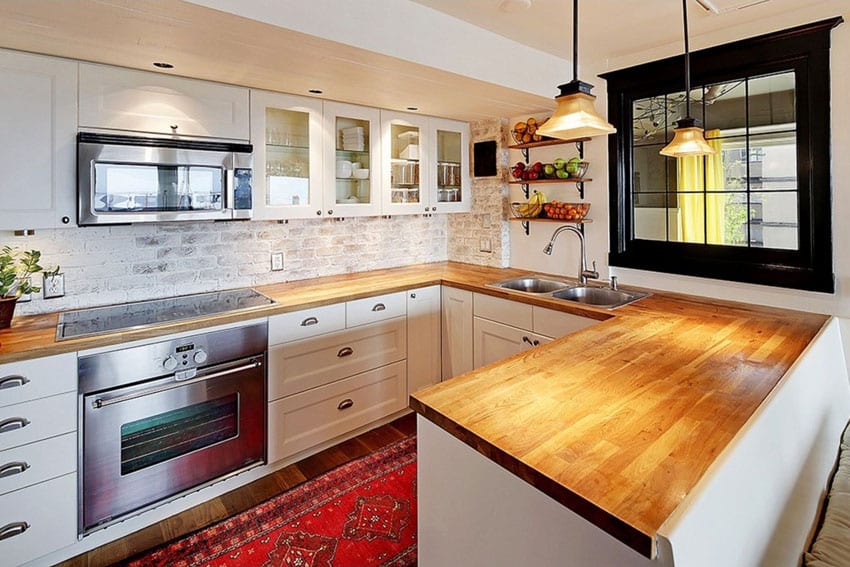 Kitchen with European cabinets and brick backsplash