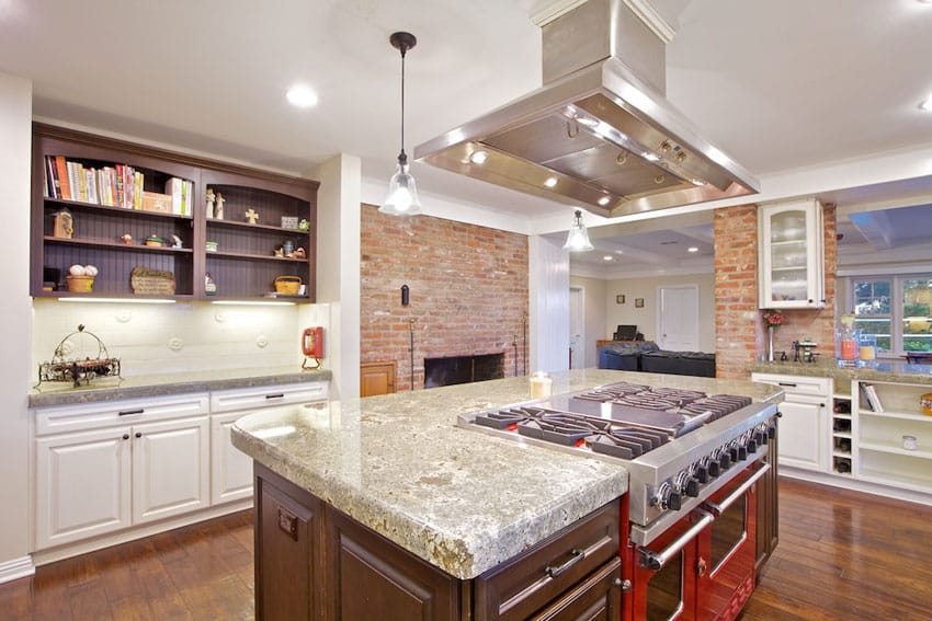 Kitchen with polished seafoam green granite counter and brick fireplace