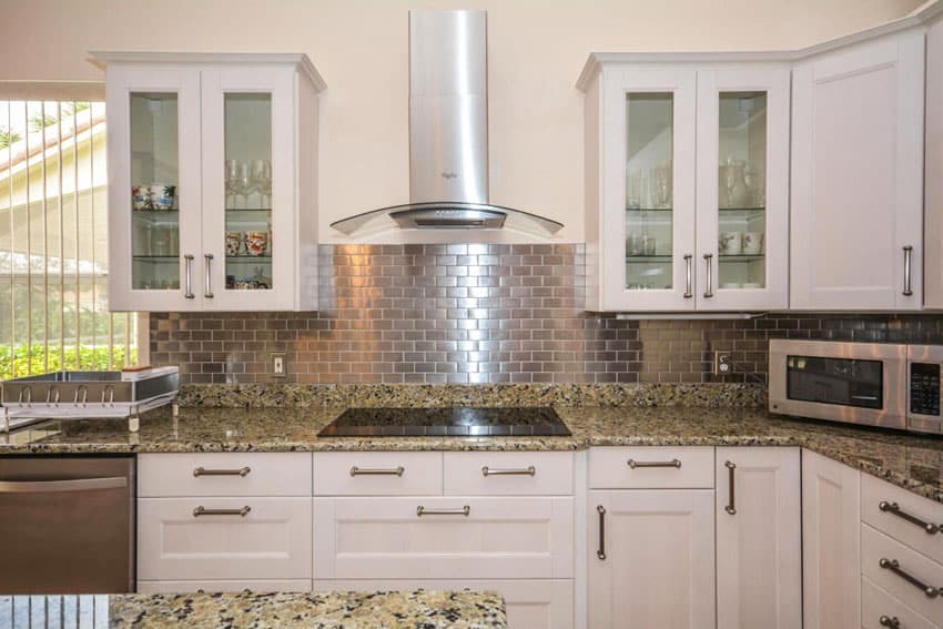 L shaped kitchen with metal mosaic stainless steel brick backsplash