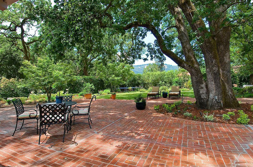 Large brick patio with traditional design and outdoor dining