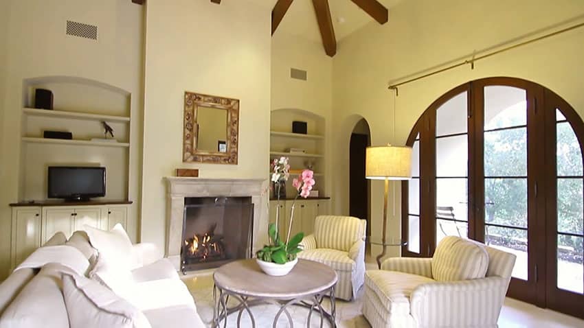 Luxury living room with exposed beam ceiling and fireplace