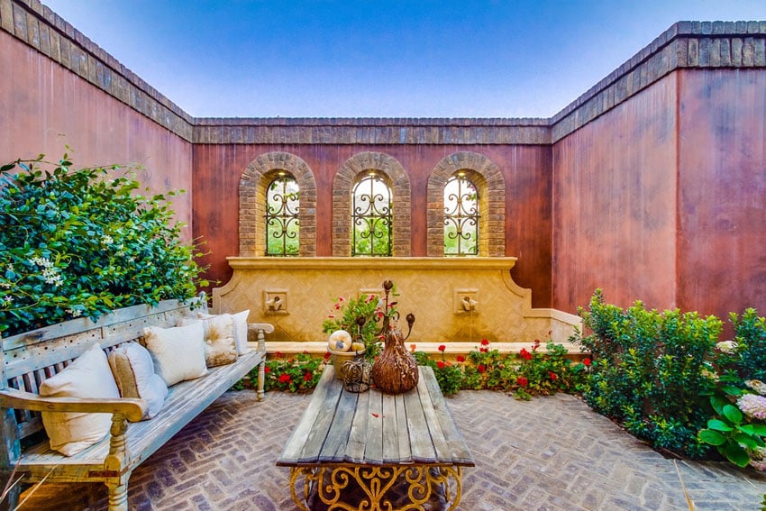 Mediterranean style patio with herringbone bricks