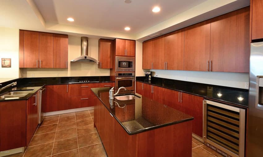 Modern kitchen with cherry cabinets dark granite counter
