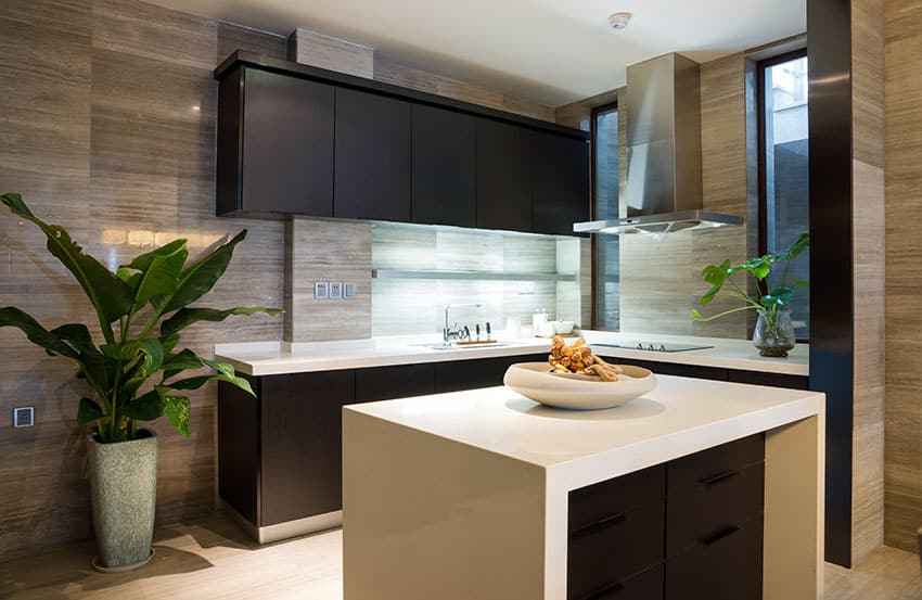 Modern l shaped kitchen with black cabinets and white counter with island