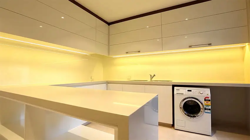 Modern basement laundry kitchen with high gloss white lacquer cabinets
