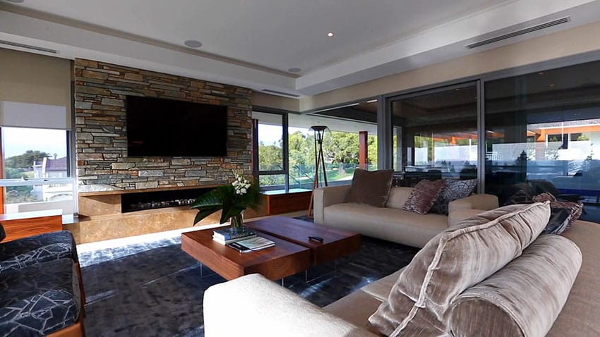 Modern living room with fireplace and stone accent wall