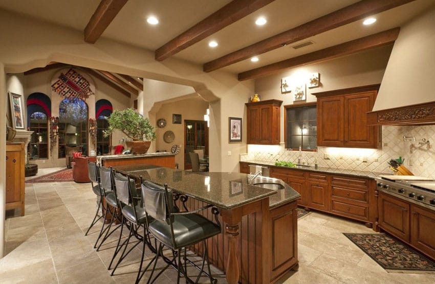 Kitchen with exposed beams and two level island