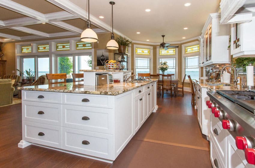 Open plan kitchen with white cabinets and traditional style