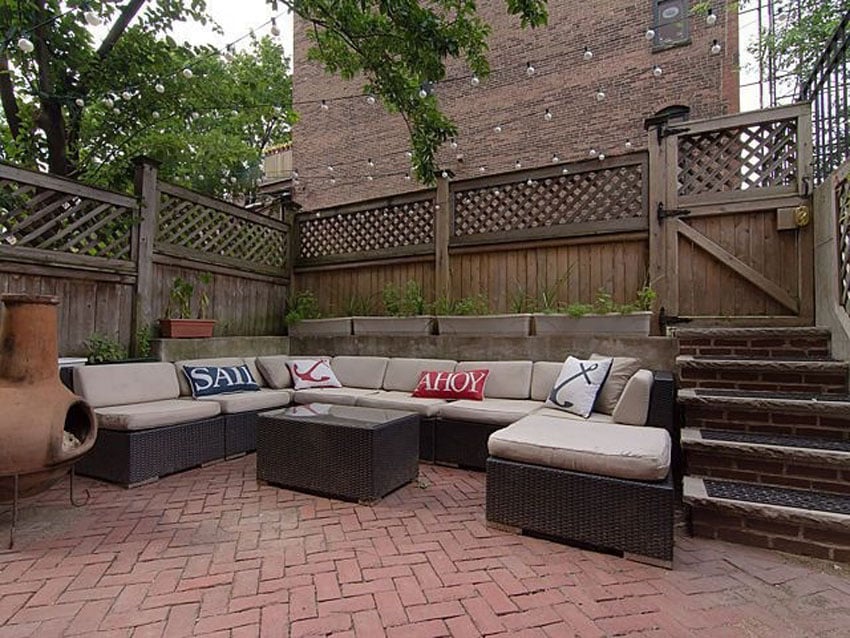 Patio with red clay paver and outdoor sectional couch