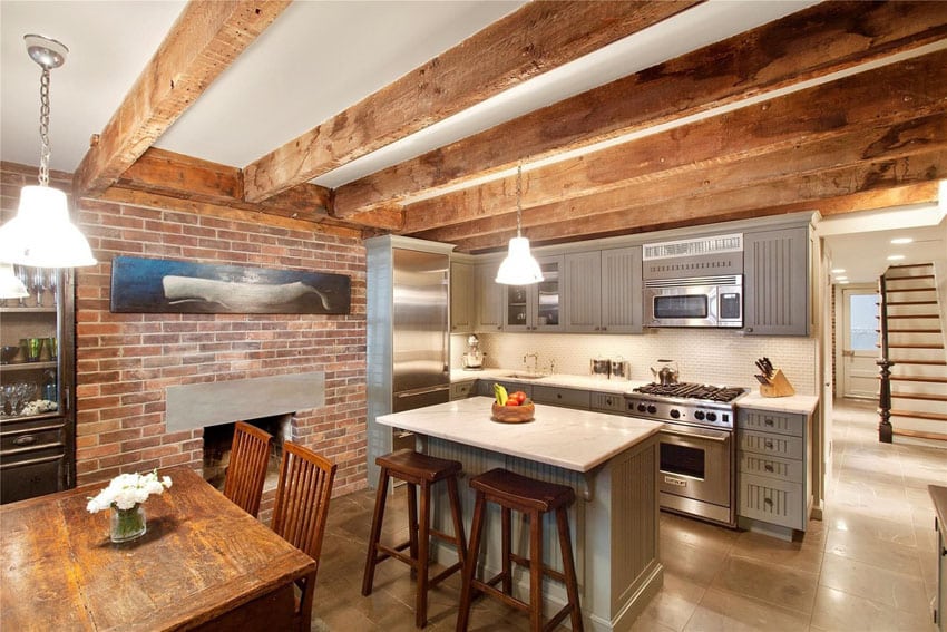 Kitchen with brick fireplace and appliances in chrome finish