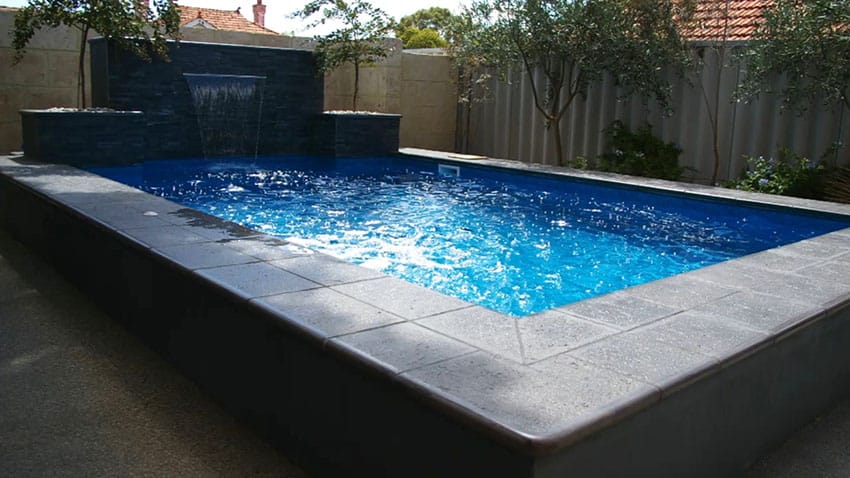 elevated pool with faux black slate tiles and cascading water design