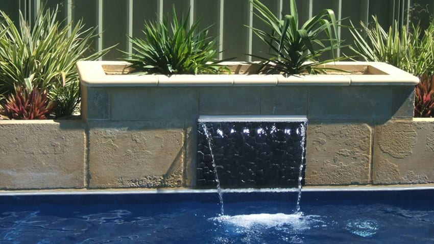 Small waterfall at side of swimming pool