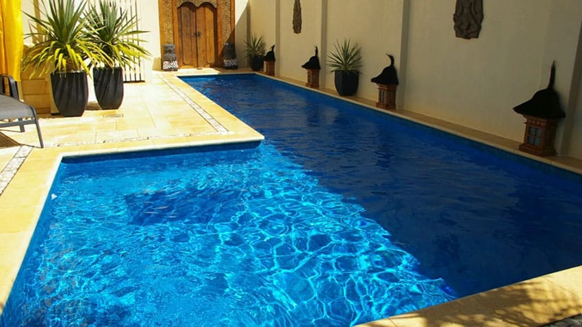 L-shaped pool at Mediterranean home courtyard