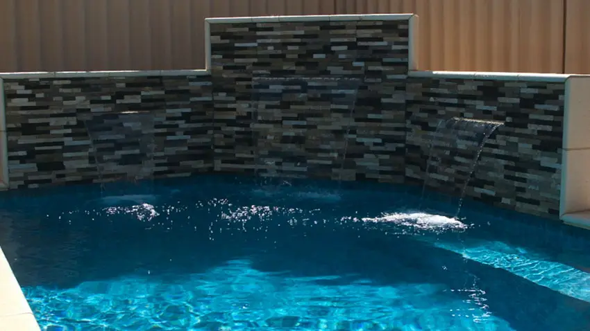 Decorative stone waterfalls in swimming pool