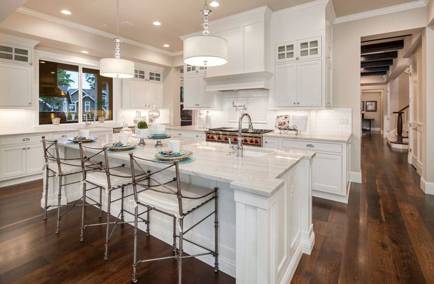 Traditional white kitchen with breakfast bar island and farmhouse sink