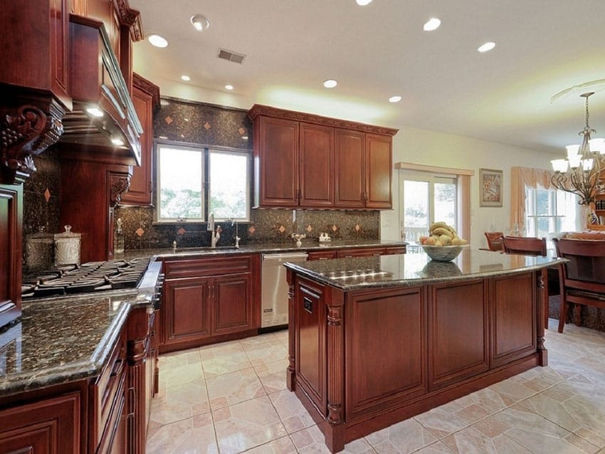 Kitchen with under cabinet lights, island with cherry base and porcelain floors