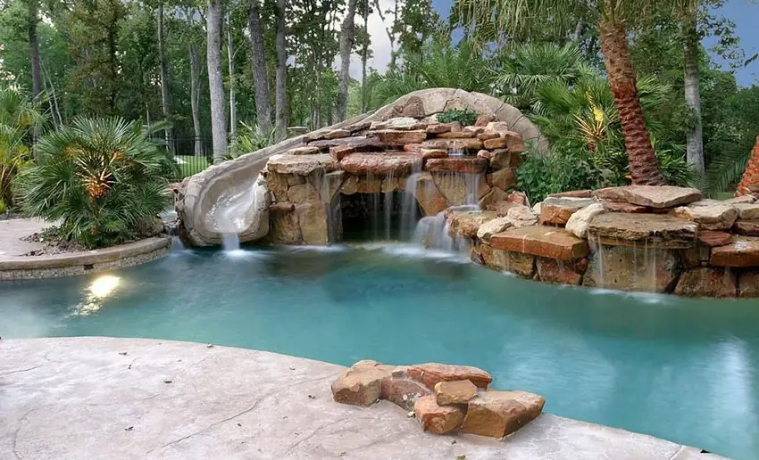 Tropical swimming pool with rock water feature waterfall