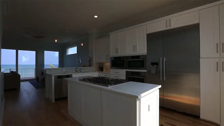 Beach house kitchen with ocean view at night