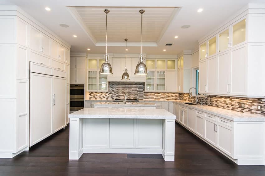 beautiful kitchen with white shaker cabinets and marble island