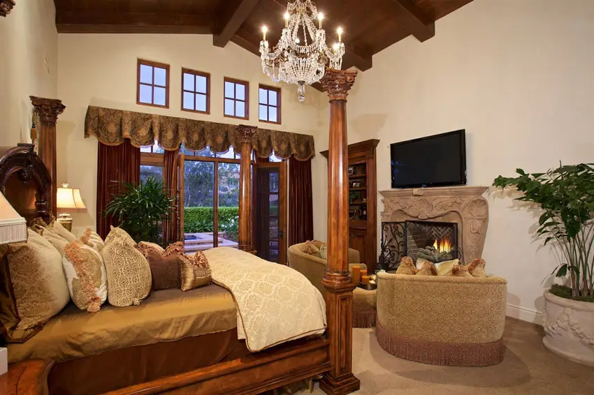Beautiful luxury master bedroom with fireplace and window views