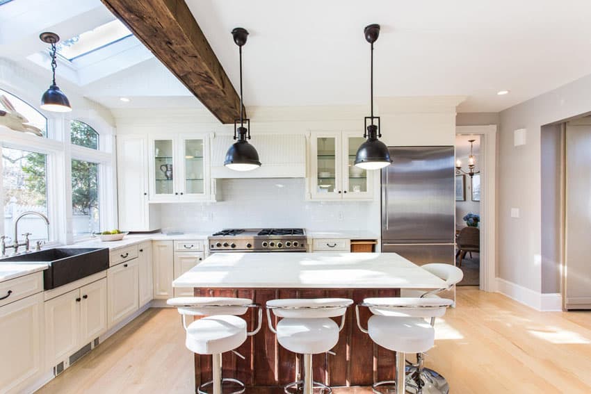 Contemporary kitchen with white cabinets black farmhouse sink, exposed beam & wood island