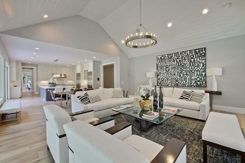 Room with pale white oak plank floors, two sofas and bench 