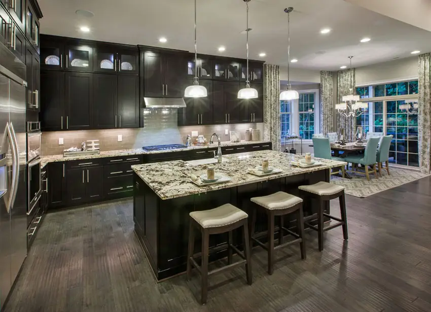 Dark cabinet kitchen with pendant lights and wooden stools