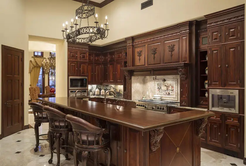 Kitchen with carved motifs and solid dark wood bi-level counters