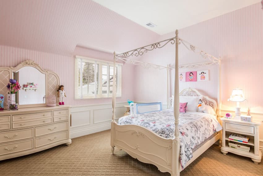 Girls pink bedroom with four post bed