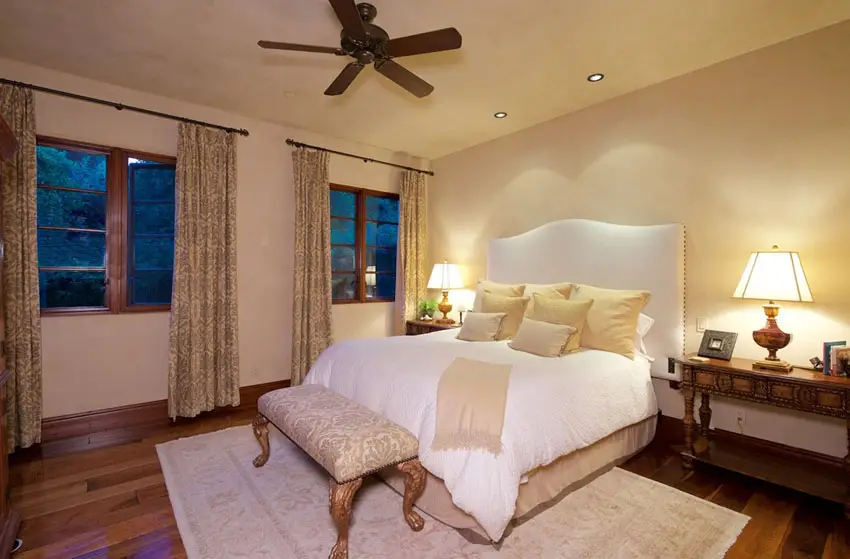 Guest bedroom with wood floors and ceiling fan