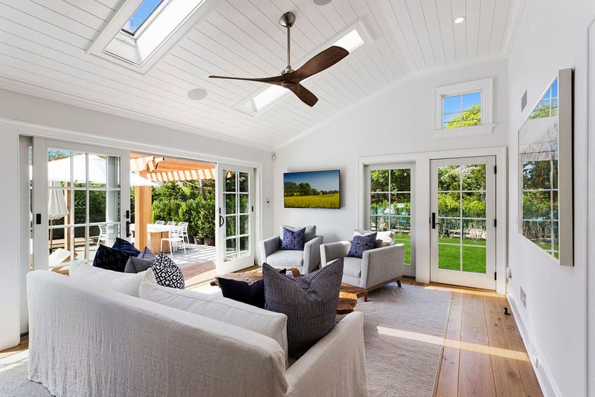 Bright window living room with skylights and maple wood floors