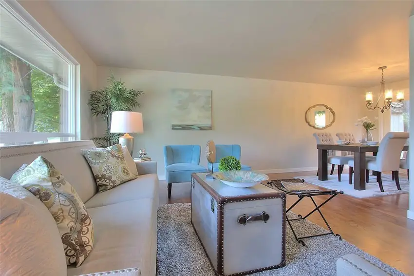 Room with blue tub chairs, shaggy rug and chest table