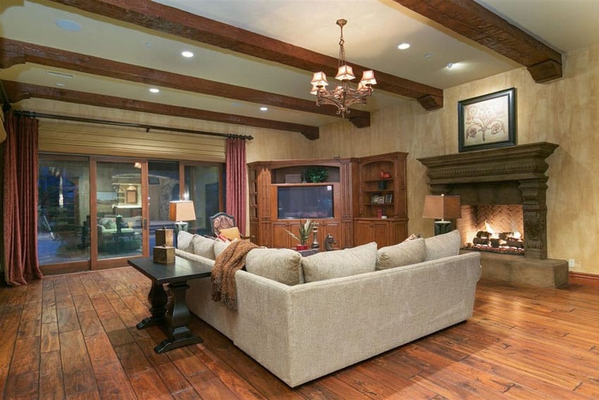 Room with marbled look walls, brown floors and light cream sectional